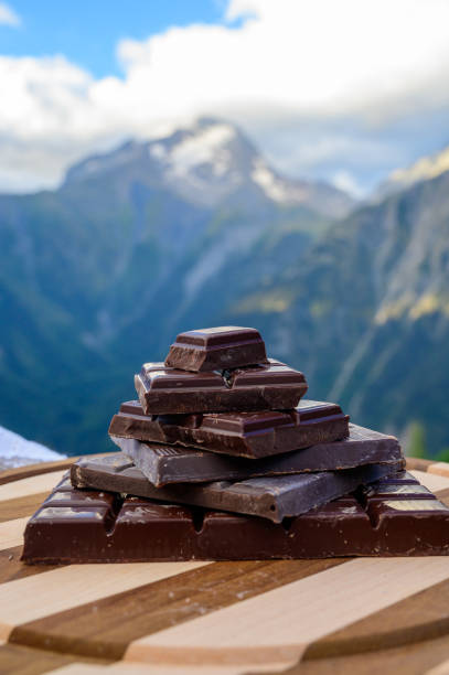istock Handmade pure dark swiss chocolate and Alpine mountains on background 1272305280