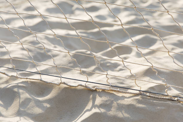 istock Stretched mesh on a white sand background, sunlight, texture, outdoors, beach vacation, sport. 1272306588