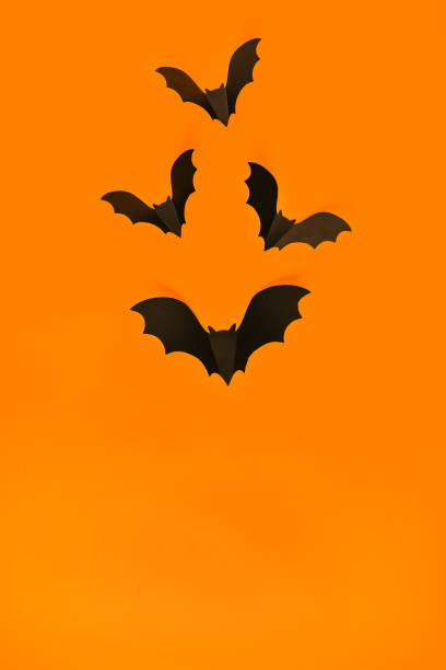 istock Cartoon Halloween background black bats on orange backdrop. Bright holiday backdrop for your design. Dark and moody background. 1272311821