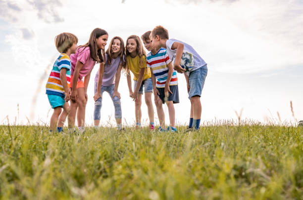 istock Group of kids talking together in nature 1272312757