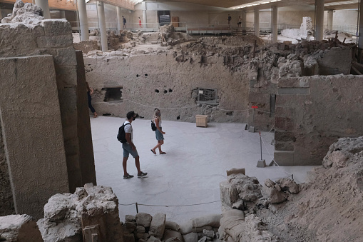 Visitors take a tour in the prehistoric city of Akrotiri which was  inhabited from the Neolithic Age to 1500 BC, when a devastating eruption destroyed everything. Santorini Island, Greece, 17 Aug. 2020
