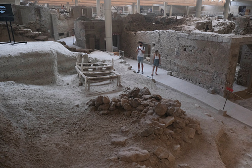 Visitors take a tour in the prehistoric city of Akrotiri which was  inhabited from the Neolithic Age to 1500 BC, when a devastating eruption destroyed everything. Santorini Island, Greece, 17 Aug. 2020