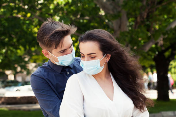 istock Young couple wearing protective face masks 1272316709