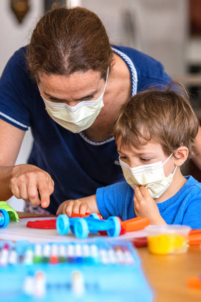 istock Child boy learning with colorful clays using face masks while locked down because pandemic 1272317586