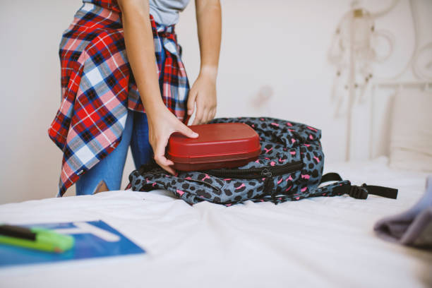 istock School girl putting school supplies into backpack 1272321367