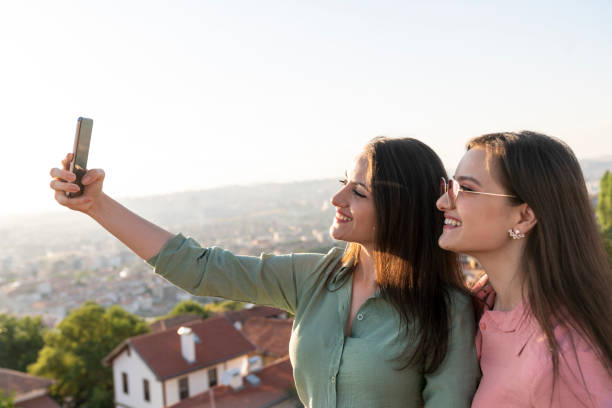 istock twin girls taking selfie 1272323131