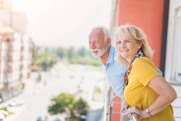 istock Happy senior couple looking at view from balcony. 1272325956
