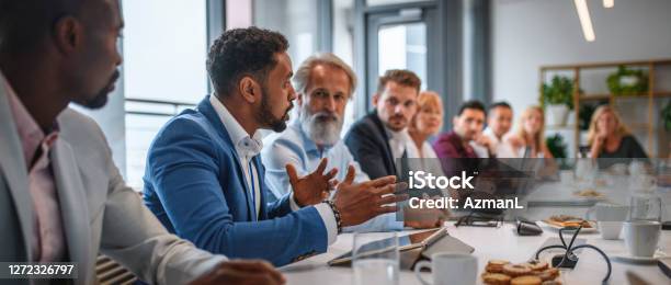 Executive Team Listening To Contrary Views From Colleague Stock Photo - Download Image Now