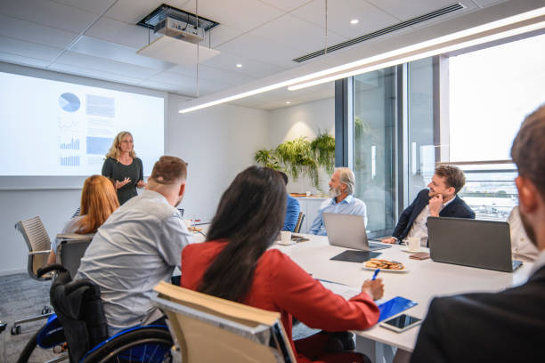istock Diverse Executive Team Listening to CEO Presentation 1272326801