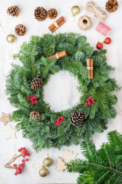 istock Handmade Christmas wreath on white wooden table 1272327155