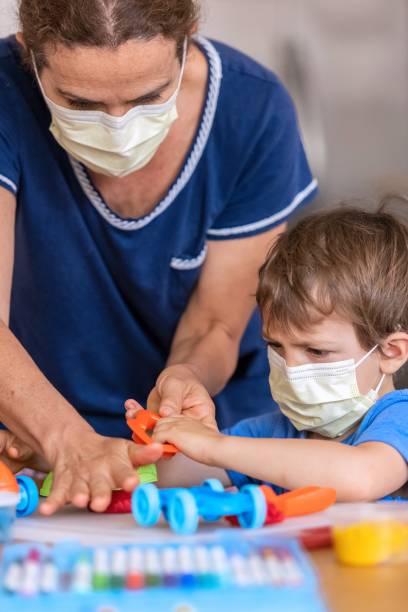 istock Child boy learning with colorful clays using face masks while locked down because pandemic 1272332018
