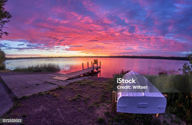 Marl Lake Magenta Life Boat Sunrise Stock Photo - Download Image Now - Michigan, Lake, Commercial Dock