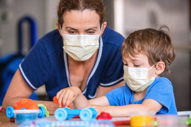 istock Child boy learning with colorful clays using face masks while locked down because pandemic 1272332046