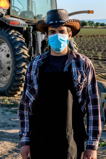 istock Farmer worker wearing a protective face mask due Covid-19 contagion prevention 1272332216