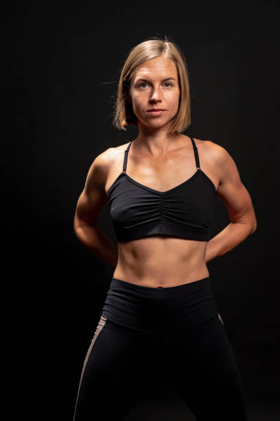 istock Blonde athlete in workout clothing stretches and warms up. 1272332963