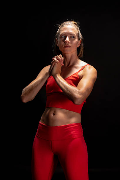 istock Blonde athlete in workout clothing stretches and warms up. 1272332967