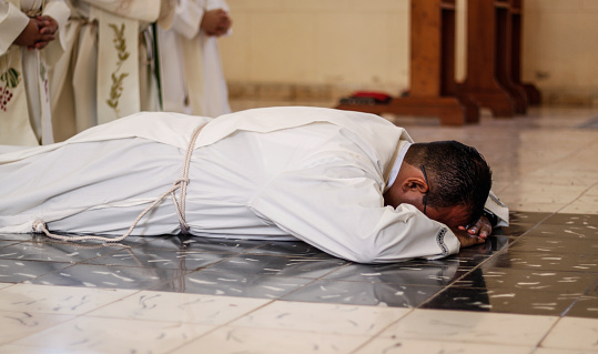 San Nicolas, May, CUB - August 28, 2020: A young seminarian prays at a religious celebration before being ordained a priest in the Archdiocese of Havana.  The mass is celebrated amid the outbreak of coronavirus cases in Havana.