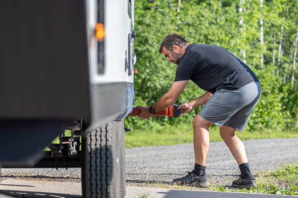 istock Man Emptying RV Sewer at Dump Station After Camping 1272334367