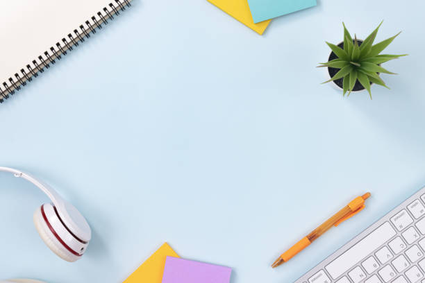 istock Top View Modern Office Desk on Blue Pastel Minimalist Background 1272343524
