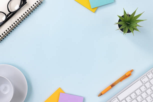 istock Top View Modern Office Desk on Blue Minimalist Background 1272343531