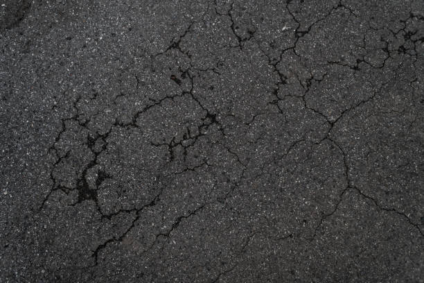 istock Crack background texture of rough asphalt top view 1272344227
