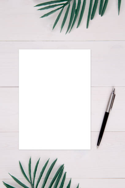 istock Blank paper sheet copy space with mockup and leaf on wooden table, poster and invitation, postcard decoration your design or branding, simplicity and minimal, nobody, flat lay, top view. 1272344343