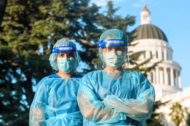 healthcare workers standing in front of a capitol building - department of health and human services imagens e fotografias de stock