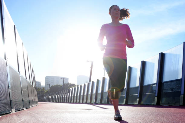 istock Young woman running on a bright pink road 1272346953