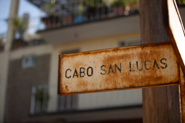 Cabo San Lucas Afternoon view of a rusted public street sign of Cabo San Lucas street in an older neighborhood of Cabo San Lucas, Baja California Sur, Mexico. baja california sur stock pictures, royalty-free photos & images