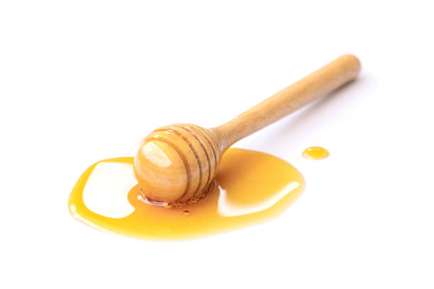istock honey with honeycomb white background 1272353149