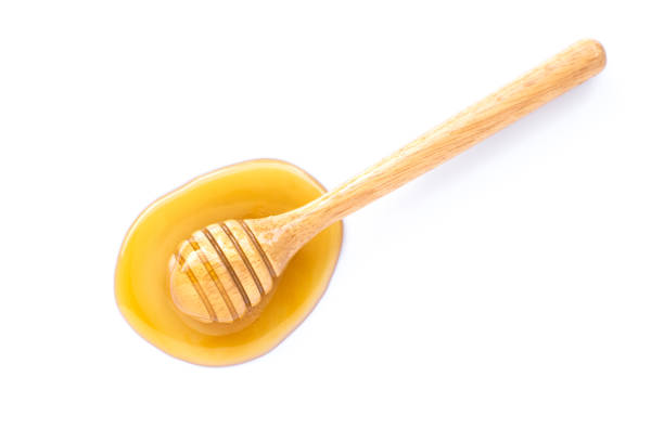 istock Honey with honey dipper isolated on white background. 1272353150