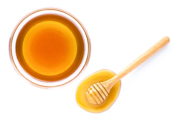 istock Honey pot and dipper isolated on white background. 1272353152