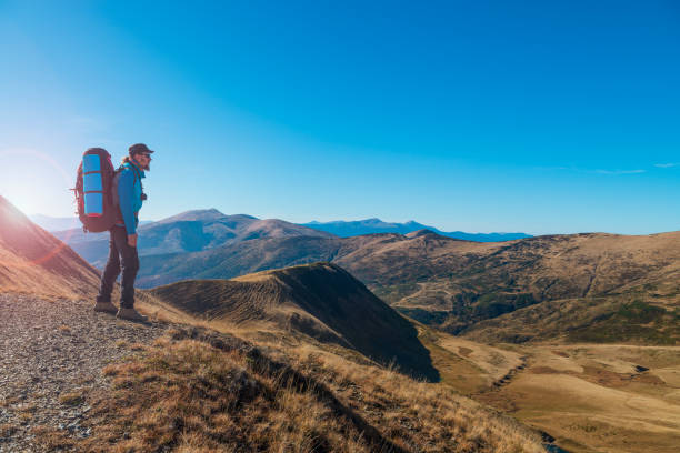 istock Hiker on the mountain top enjoys the view 1272359298