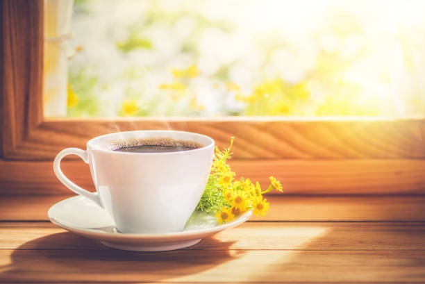 istock Coffee and flower placed by the window with morning sunlight 1272361331