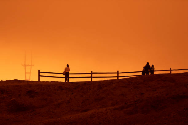 San Francisco California, USA - September 9, 2020: The sky across California darkened and stayed orange during day as smoke from many wildfires across the state created a massive smoke cloud changing the sunlight to a perpetual orange glow.