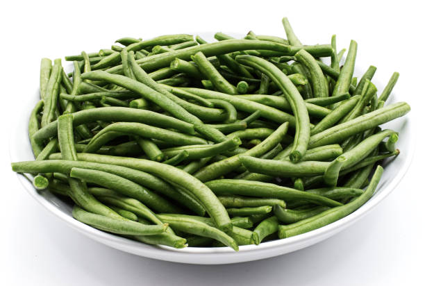 istock Boiled green beans in a bowl isolated on white background 1272362695