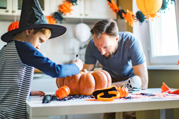 istock Father and son getting ready for Halloween party at home 1272363910