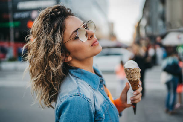 istock Young woman enjoying ice cream 1272365110