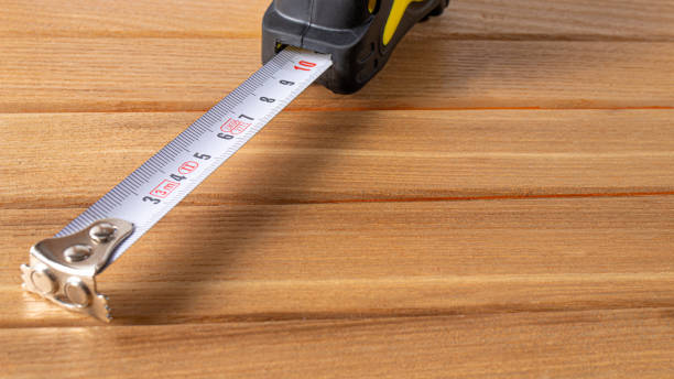 istock Measuring tape with numbers centimeters on a wood brown background. 1272367772