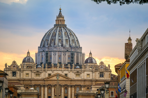 Rome, Italy, September 11 -- The sunset light after the rain on the majestic dome of the St. Peter's Basilica. The Basilica of St. Peter, in the Vatican, is the center of the Catholic religion, one of the most visited places in the world and in Rome for its immense artistic and architectural treasures. Photo in HD format