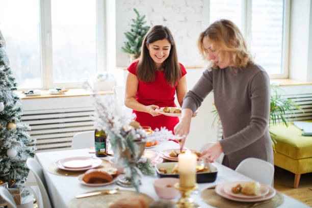 istock Woman friends setting the table before christmas celebration 1272369988
