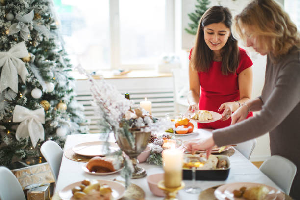 istock Woman friends setting the table before christmas celebration 1272369991