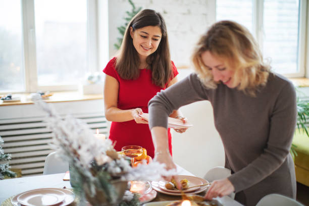 istock Woman friends setting the table before christmas celebration 1272369999