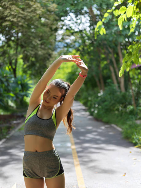 istock Female athlete stretching her arms before exercise in the park 1272371413