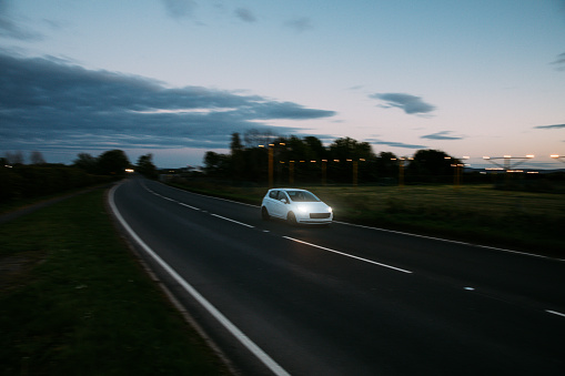 Car speeding in the night in northern europe.