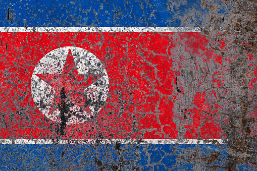 North Korea flag on grunge textured background