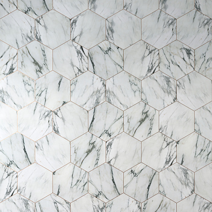 Hexagonal multi-colored tile pattern - geometric creative background of white and gray marble grid texture with golden fugues. 3D rendered image.