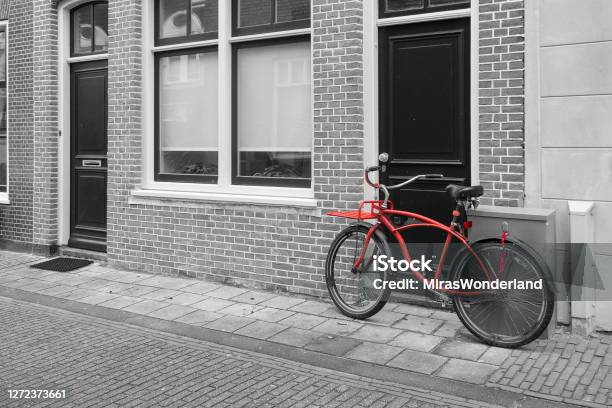 Red Bicycle In An Old Street In A City In The Netherlands Europe Stock Photo - Download Image Now