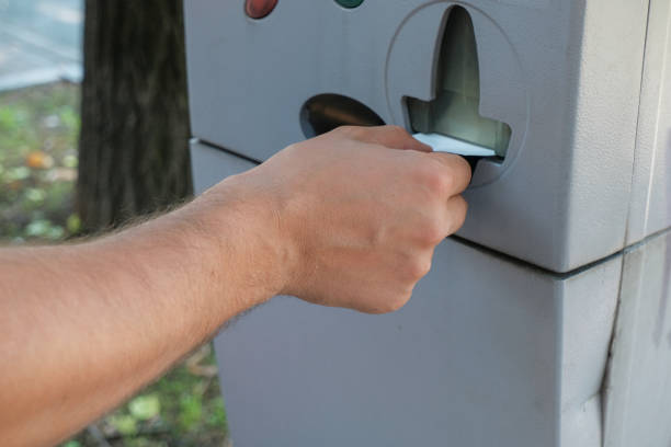 istock person taking parking check/ticket from a parking machine/vending machine. Hand close-up. Transportation. City infrastructure 1272374741