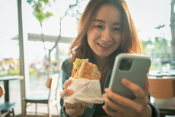 istock Woman Using Smart Phone At Coffee Shop 1272377321